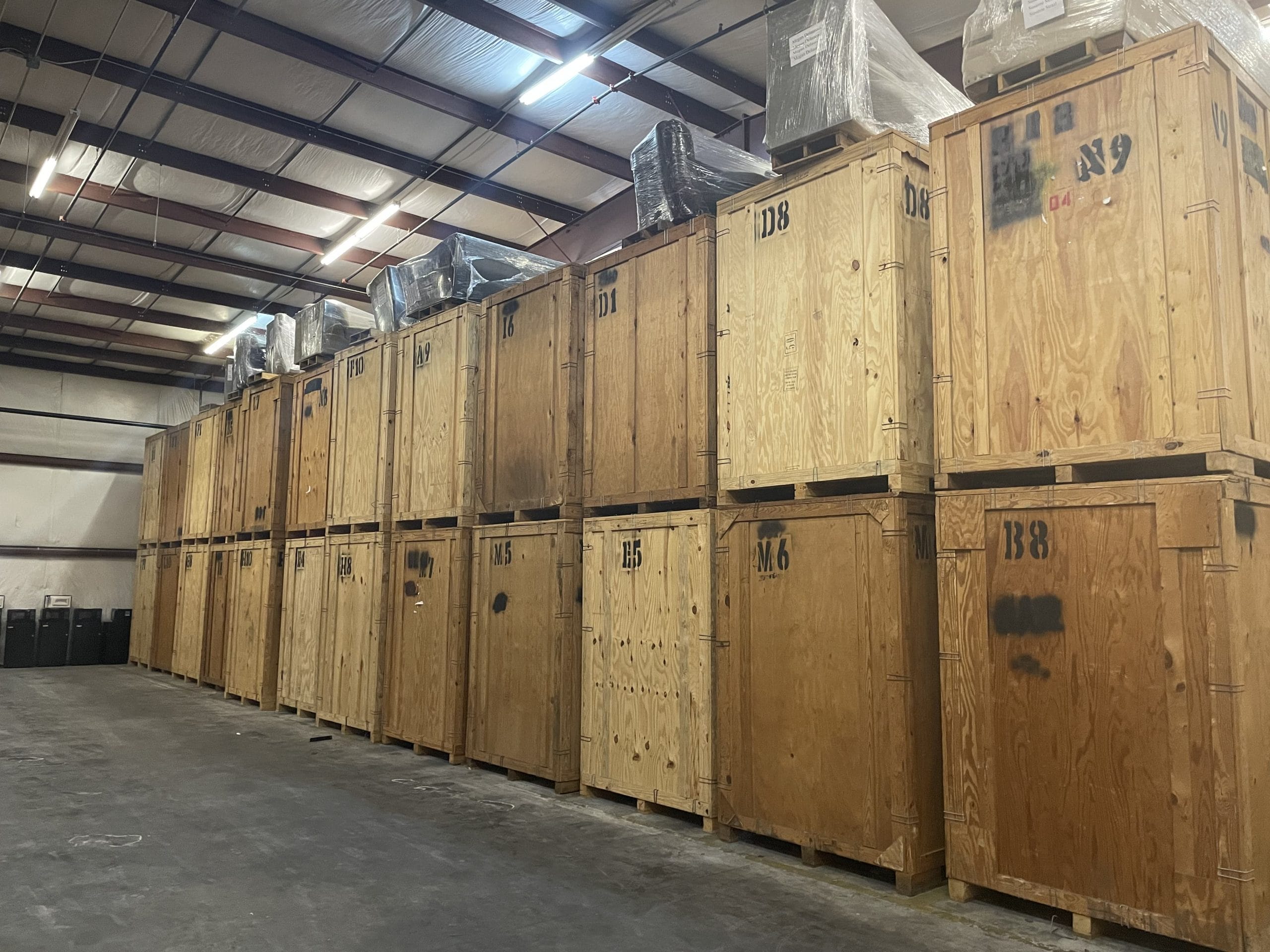 Rows of large wooden crates are stacked inside EverSafe Moving Co.’s secure storage facility