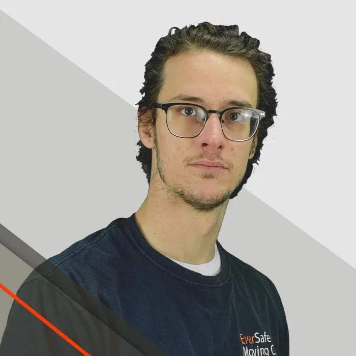 Joe, Mover, wearing a glasses and a dark EverSafe shirt poses against a clean, modern background