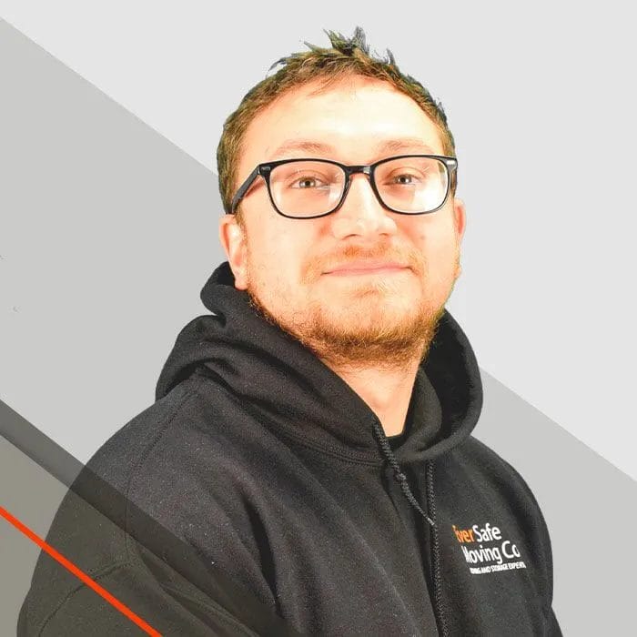 Lou, Mover, wearing a glasses smiles in an EverSafe hoodie for a team photo 