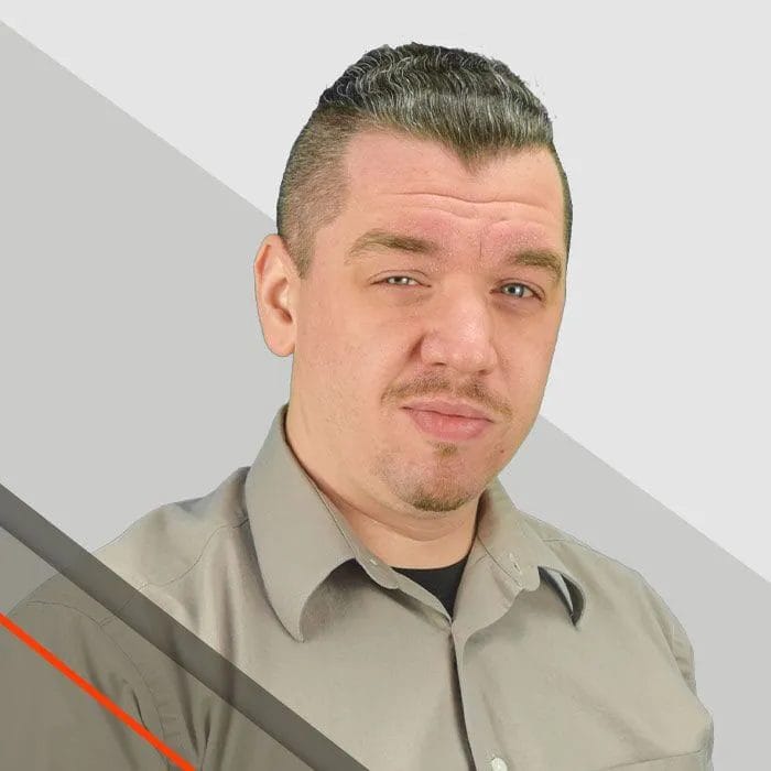 Mike, Estimator, wearing a tan shirt gives a confident look against a light backdrop