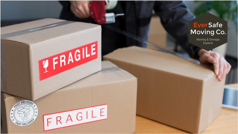 A man sealing a cardboard box with packing tape, featuring a visible 'Fragile' label on the side, indicating careful handling is needed.