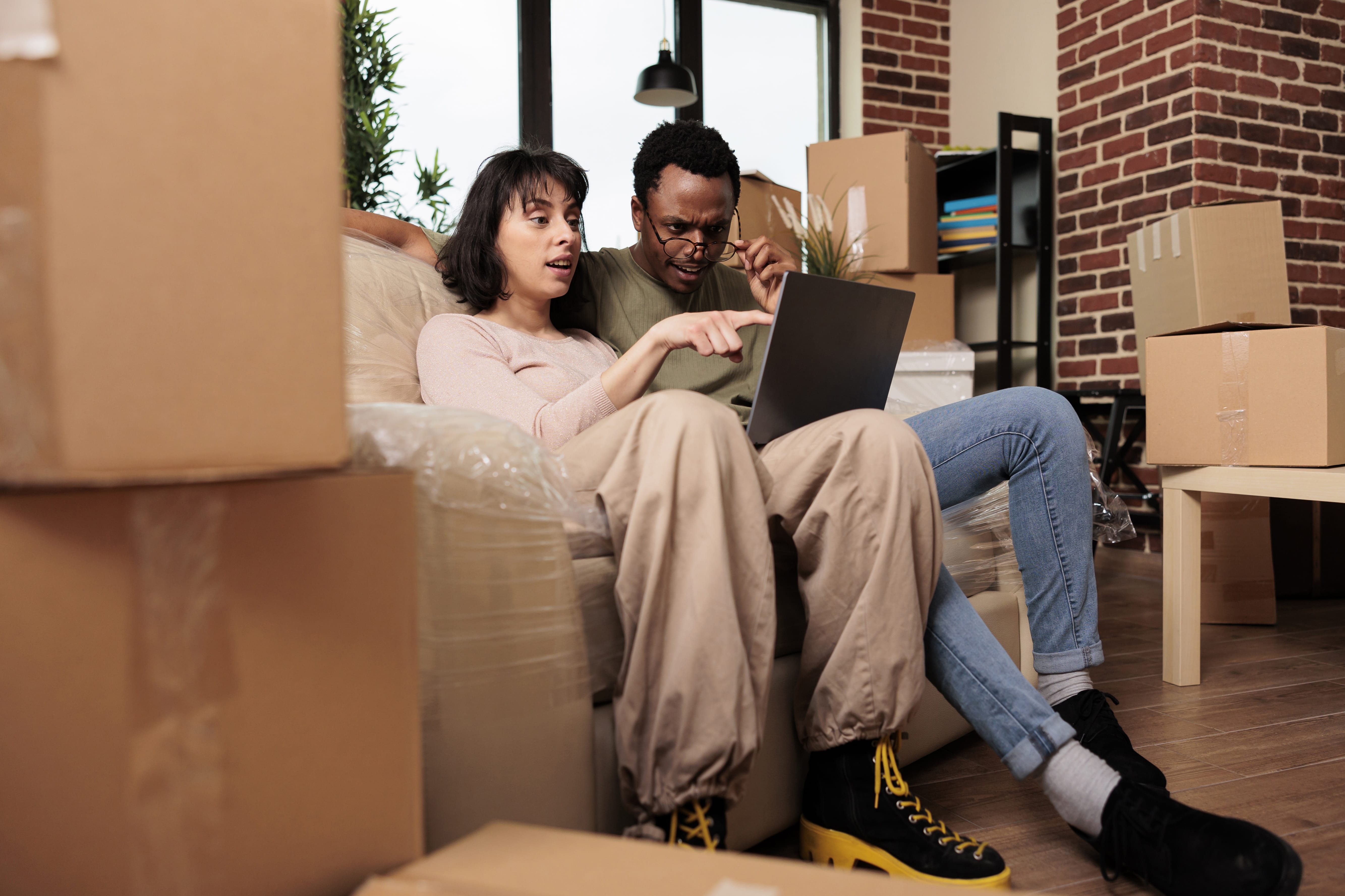 Couple preparing for a move while researching what to know before hiring